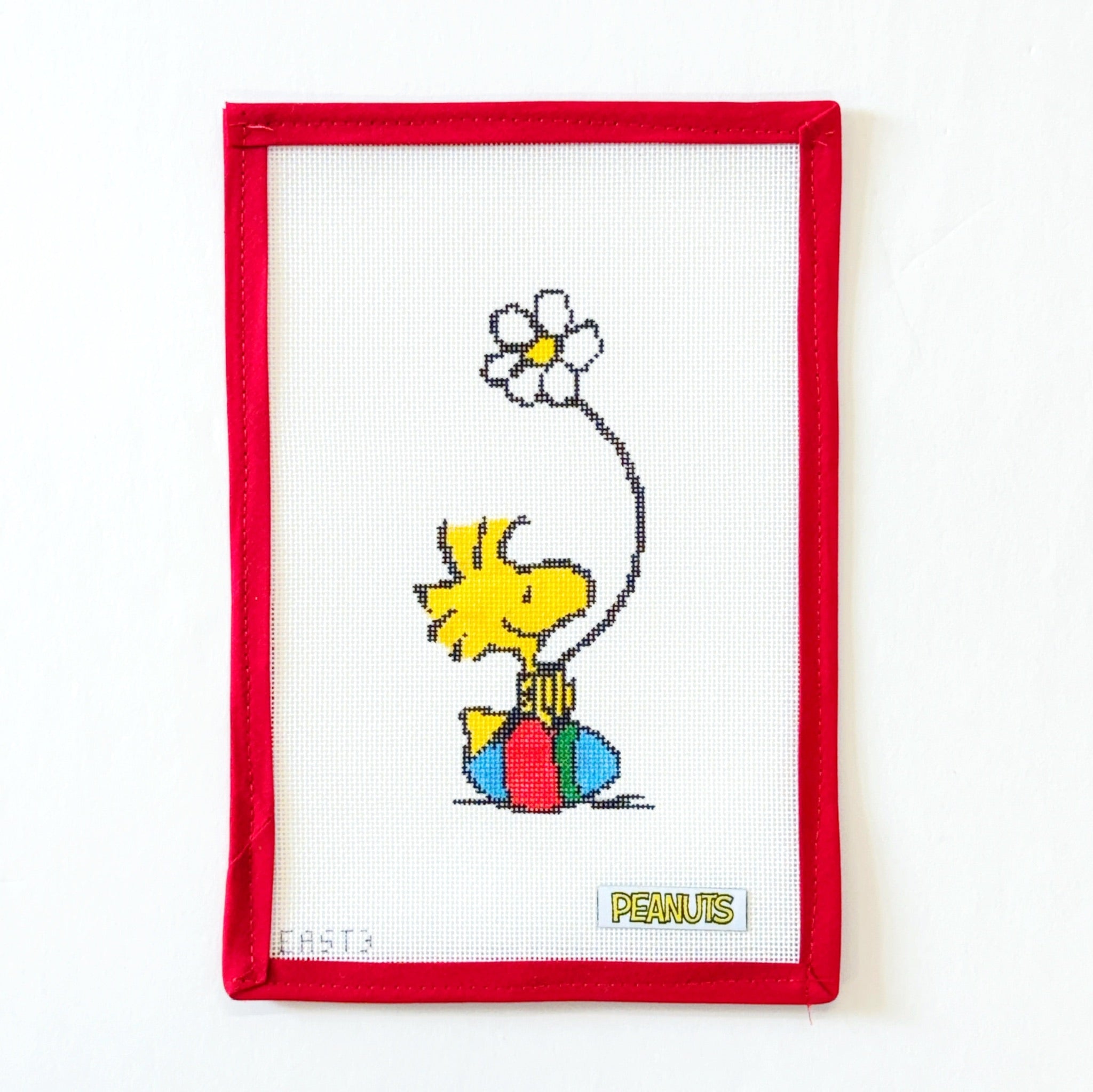 Woodstock Sitting on Easter Egg with Daisy - PeanutsOfficially NeedlepointCanvasThe Red Thread Atelier